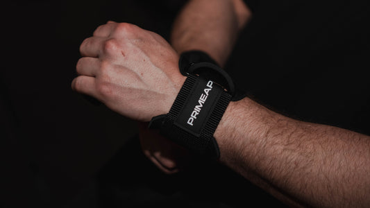 hands of a person wearing a Prime Ape figure 8 lifting strap on their wrist, showcasing its durable design and snug fit.