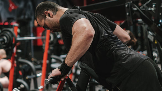 Man performing dips exercise on a machine in a gym setting